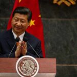A political leader giving a speech and applauding