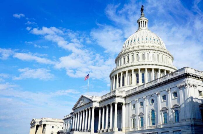 The U.S. Capitol building with an American flag flying under a blue sky