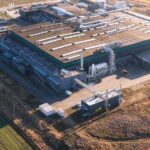 Data Centers INVADE—Who Picks Up the Tab? Aerial view of a large industrial facility with various structures and equipment