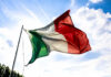 Italian flag waving against a blue sky