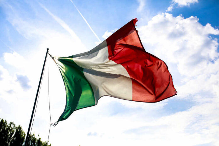 Italian flag waving against a blue sky