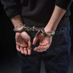 DHS SLAMS Local Policies — Families Demand Justice Person's hands cuffed behind their back