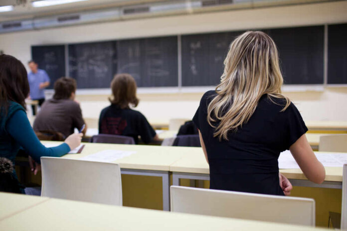shutterstock_64165846.jpg Students seated in a classroom listening to a teacher