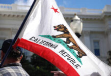 California state flag being held up at an outdoor event