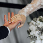 Hands of a couple wearing wedding bands
