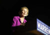 Woman speaking at a podium with microphone.