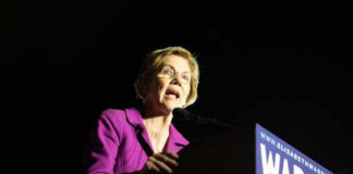 Woman speaking at a podium with microphone.