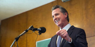 Man speaking at podium with microphone