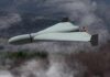 Border Tension: Mystery Drone Sparks Urgent Action Flying wing drone with pusher propeller over foggy forest