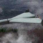 Border Tension: Mystery Drone Sparks Urgent Action Flying wing drone with pusher propeller over foggy forest
