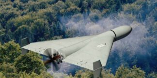 A kamikaze drone flying over a dense forest