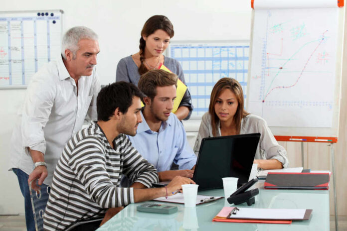 picture-of-a-business-meeting93566035jpg Five people working together in an office meeting.
