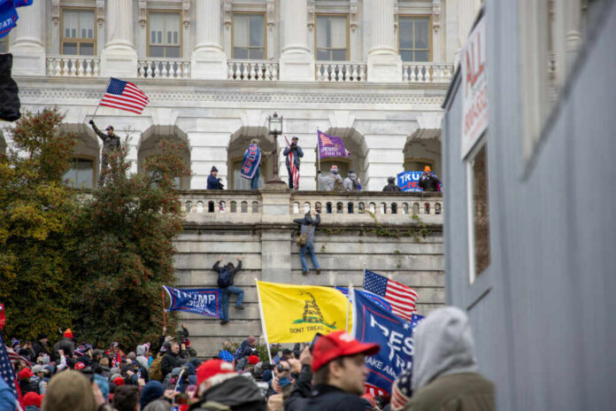 protestors-descend-upon-capitol-hill1888539481jpg Crowd with flags gathered outside a neoclassical government building