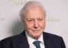Elderly man in formal attire smiling at the camera