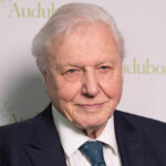 Is Attenborough’s Legacy More Than Just Names? Elderly man in formal attire smiling at the camera