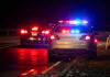Shocking Britney Arrest Footage Leaks — What Happened? Police car with flashing lights parked on the roadside at night