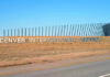 Sign for Denver International Airport against a clear blue sky