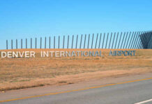 Sign for Denver International Airport against a clear blue sky