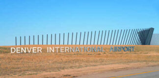 Sign for Denver International Airport against a clear blue sky