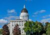 Maine Senate Race ROCKED by Nazi Symbol State capitol building with a dome under a clear blue sky
