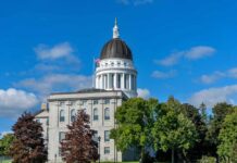 State capitol building with a dome under a clear blue sky