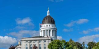 State capitol building with a dome under a clear blue sky