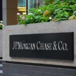Viral Lawsuit: JPMorgan’s “Hidden” Abuse Allegations Sign for JP Morgan Chase & Co. with flowers in the foreground