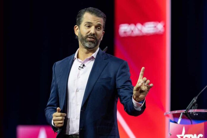 A man speaking at a conference with a microphone in hand
