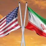 U.S. Strikes Halted: What Does Iran Get in Return? Flags of the United States and Iran crossed against a sunset background
