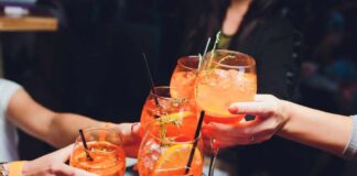 Group of friends toasting with colorful cocktails