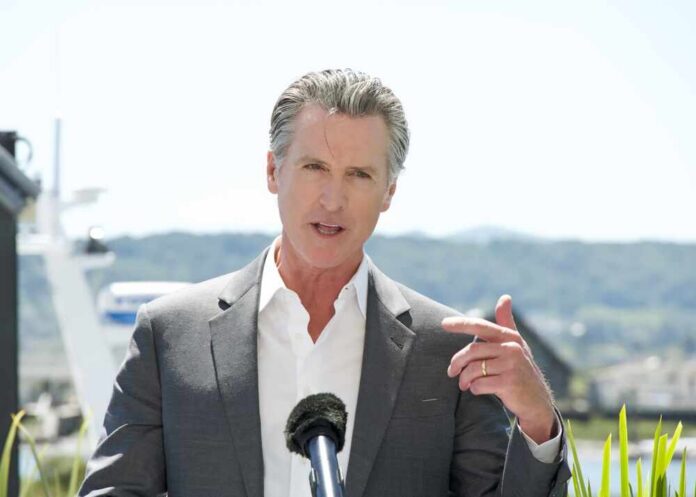 A man in a suit speaking at a press conference outdoors