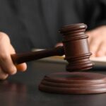 Trump’s Emergency Powers BLOCKED by State Judge A judge's hand holding a gavel above a wooden block