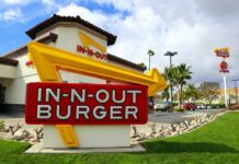 In-N-Out Nightmare: Armed Suspect Still Loose! In-N-Out Burger restaurant sign with a bright yellow arrow
