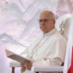 Pope’s Bold Move: AI Weapons Under Fire Pope seated in a ceremonial chair with flags in the background