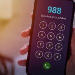 Shocking Hotline Failure: Calls Dropped, Help Denied A smartphone displaying the 988 Suicide & Crisis Lifeline dial pad