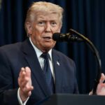 Trump’s Influence Fuels Republican Fundraising Surge A man in a suit speaking into a microphone during a public address
