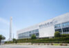 SpaceX headquarters with Falcon 9 booster displayed outside