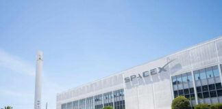 SpaceX headquarters with Falcon 9 booster displayed outside