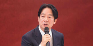 A man speaking into a microphone indoors