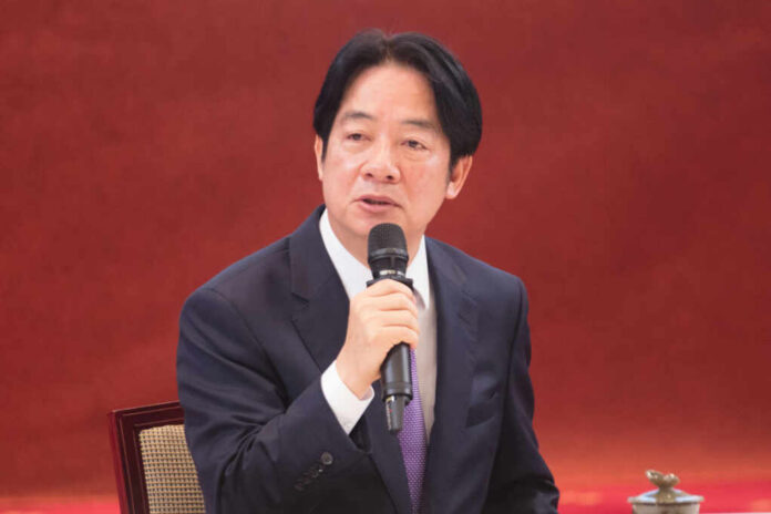 A man speaking into a microphone indoors