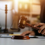 Controversial Insanity Verdict Sparks Outrage In Florida Judge's hand holding a wooden gavel above a sound block