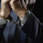 Outrage Erupts: No Registry, Still A Lawyer Businessperson in suit with hands cuffed together