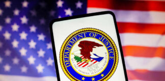 Department of Justice seal on phone, American flag background.