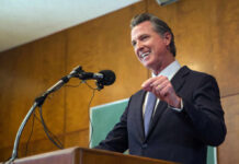 Man speaking at podium with microphone