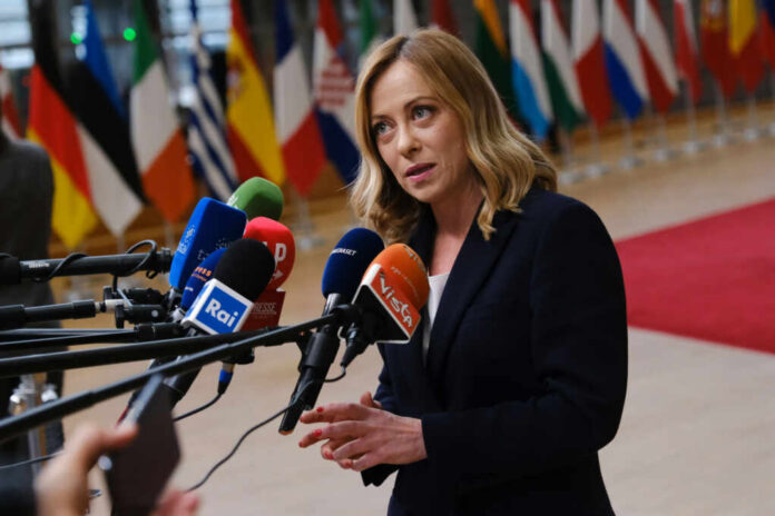 italys-prime-minister-giorgia-meloni2446907257jpg Woman speaking at a press conference with multiple microphones