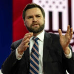 Vance Draws Red Line on Iran Cash Deal Man in suit speaking on stage with gesturing hands