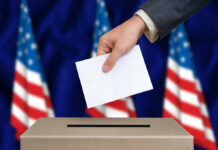Guilty Plea — Still On The Rolls? Hand placing envelope into ballot box with flag background