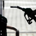 Gas Prices Fall? Trump Says Not Fast Enough Silhouette of a hand holding a fuel nozzle at a gas station
