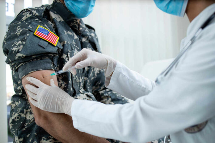 American,Soldier,Getting,Vaccine,Shot,During,Corona,Virus,Pandemic.,Military A healthcare professional administering a vaccine to a soldier