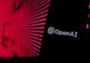 A Quiet Move With Huge Stakes Close-up of a smartphone displaying the OpenAI logo against a vibrant digital background